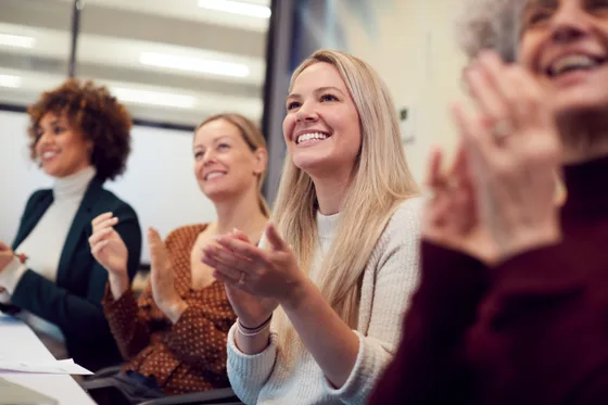 A group of women clapping