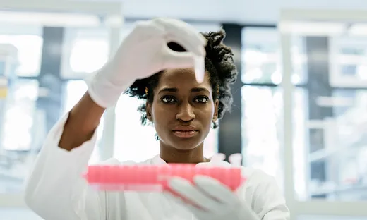 Medical professional looking at a vial