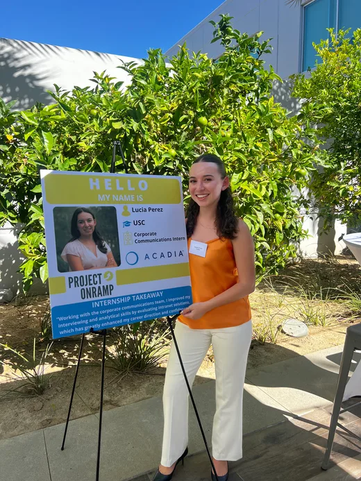 Intern named Lucia Perez presenting her internship project poster, detailing her role and experience with Acadia’s Corporate Communications team