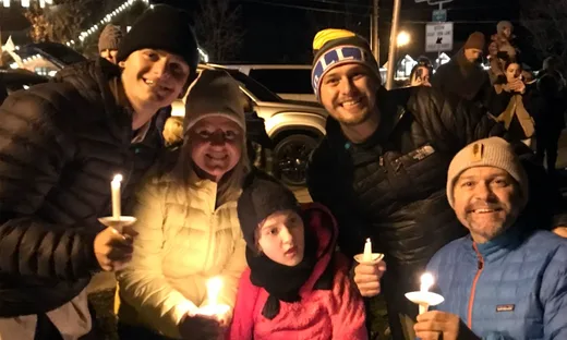 Group of individuals holding candles