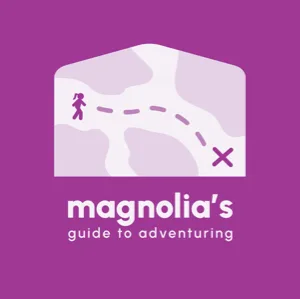 Logo for ‘Magnolia’s Guide to Adventuring,’ featuring a whimsical map design with a path leading to an ‘X’ destination, on a purple background