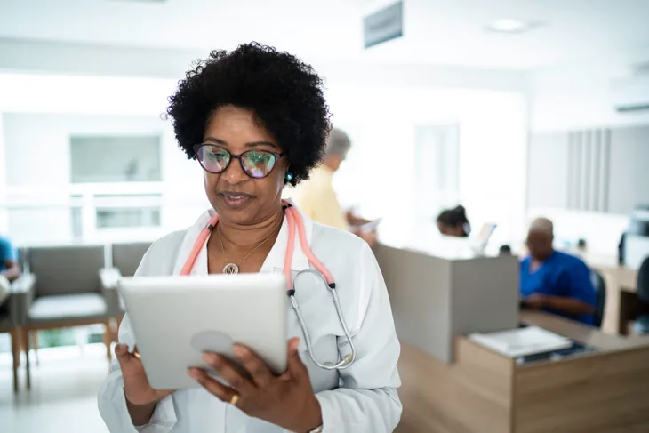 A doctor reading off an iPad